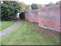 TM2858 : The entrance to All Saints Church and the wiggly wall by Geographer