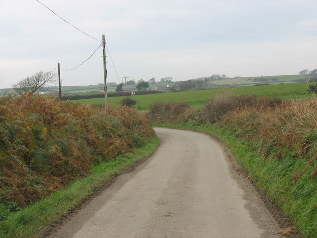 A bend on the Ty Croes road with a view across the fields to Treruffydd Farm