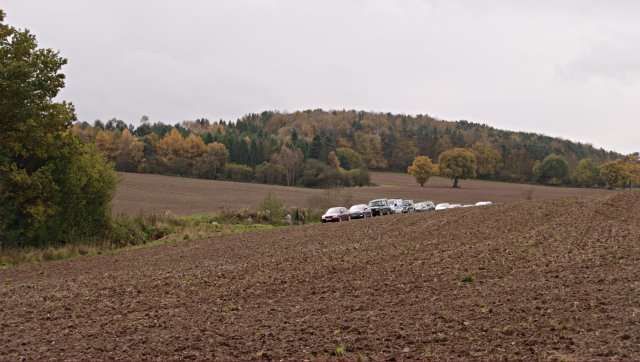 Cars in a ploughed field