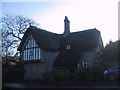 Thatched cottage in the shadows