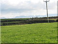 View across cultivated grassland towards Tan-lon