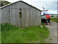 Rotting shed and beached boat