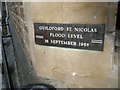 Historic sign on wall of St Nicolas Church, Guildford