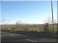 SH4574 : View SE across farmland from the Bryn Cefni Industrial Estate access road by Eric Jones