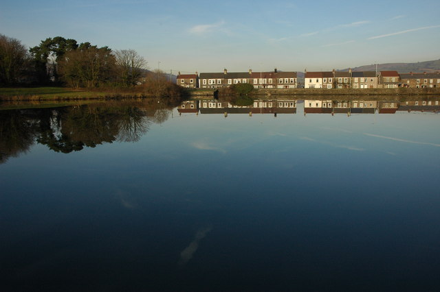 Houses reflected in North Lake, Caerphilly