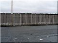 NS5465 : Fence alongside Industrial Estate on Craigton Road by Stephen Sweeney