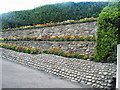 Flower beds along the wall on the footpath, on the seafront of Sheringham