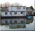 Two-story houseboat with pedalo tender