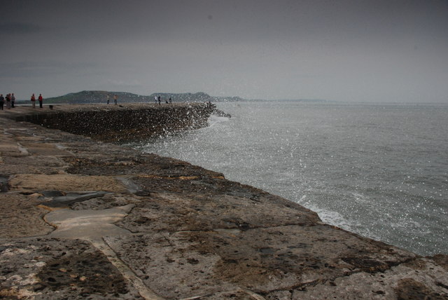 Spume breaking on the Cobb at Lyme Regis