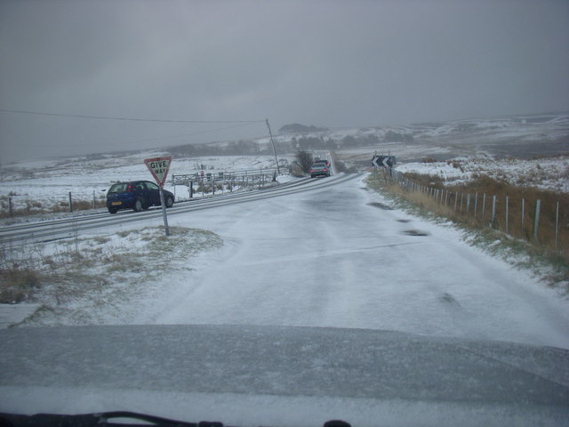 A snowy junction with the A697 and Thrunton Road