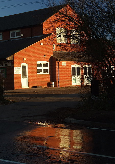 Stapleford Abbotts village hall reflected on a wet road