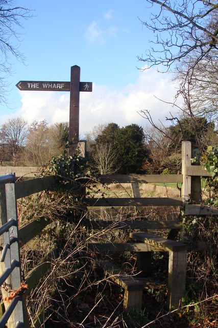 Stile and sign for the walk to the wharf