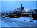 Junction of a snowy Second Avenue and Medina Road