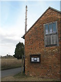 TQ0559 : Notice board on the barn in Wisley Lane by Basher Eyre