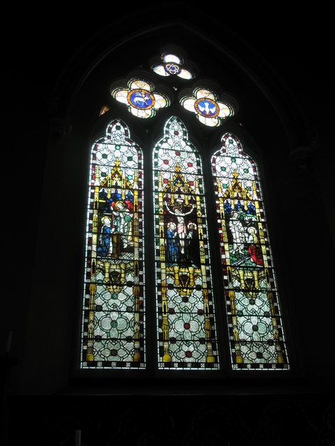 Stained glass windows above the altar at St John the Evangelist, West Meon
