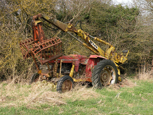 Abandoned Massey Ferguson tractor with Webb grab