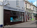 SX9265 : Optician, and charity shop, St Marychurch precinct by Joan Vaughan