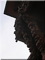 Wooden carvings over the entrance to the Mandir