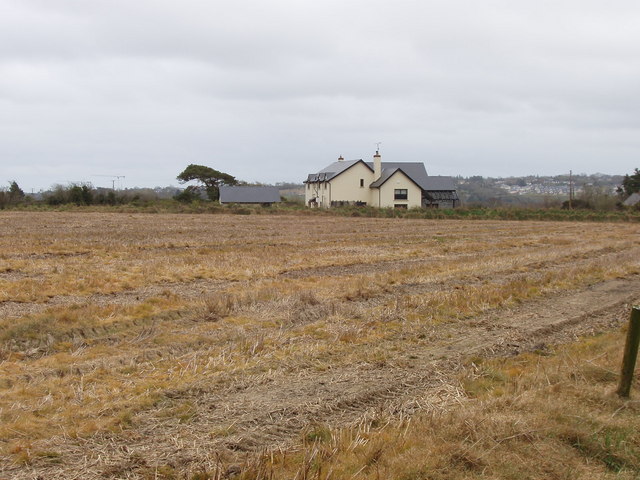 Stubble field with house beyond