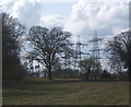 Field and trees with electricity substation beyond