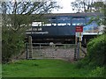 SX9786 : Train passes over the crossing at Exton by Sarah Charlesworth