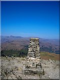 NY3405 : Trig Point on Loughrigg with distant views of the Langdales by Peter Johnson