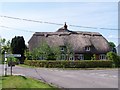 Thatched cottage by road junction at Houghton