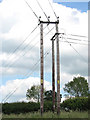 Electricity poles in meadow