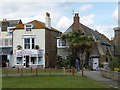 West Bay: thatched cottage with palm trees