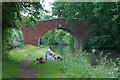 Angler adjacent a canal bridge