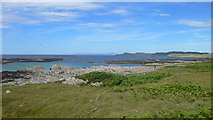 NR3391 : Looking north from the Ardskenish peninsula along the west coast of Colonsay with Mull on the horizon by Peter Edwards