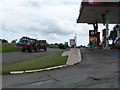 Farm traffic on A376 passing the garage near Clyst St George