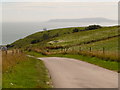 SY7482 : Ringstead: the road down by Chris Downer