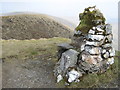SH8621 : Drws Bach cairn, looking towards Drysgol by David Medcalf