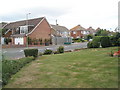 Looking from Village Road over to a bus shelter in  Jellicoe Avenue