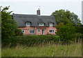 Cottage with outlook across wide open fields