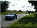 Traffic passing South Whimple farm on the old A30 near Exeter Airport