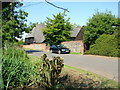 Converted barn opposite pond, Westley