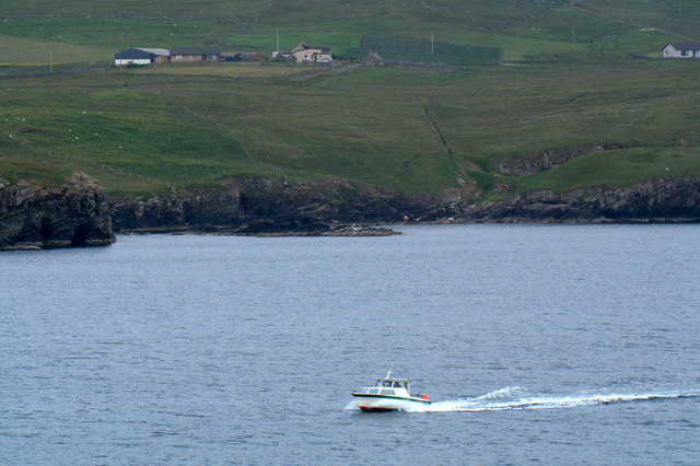 Small boat passing Kirkabister, Bressay