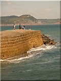 SY3491 : Lyme Regis: end of harbour wall, with Golden Cap beyond by Chris Downer