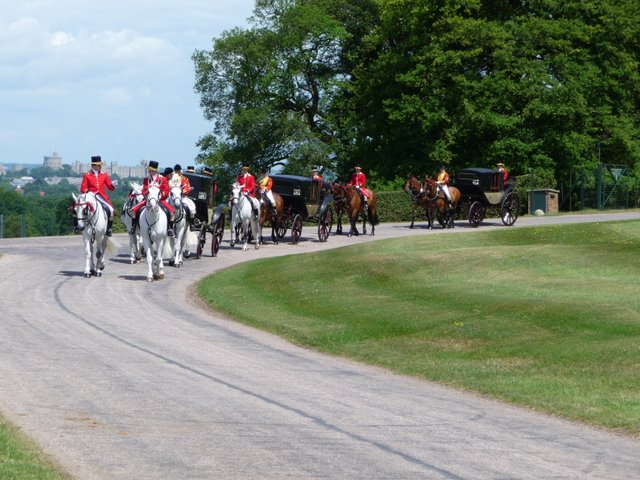 Queen's Carriage Procession, with castle backdrop enters Duke's Lane to pick up the Queen and take her to Royal Ascot. 