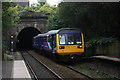 Class 142 train emerges from tunnel at Oldham Werneth