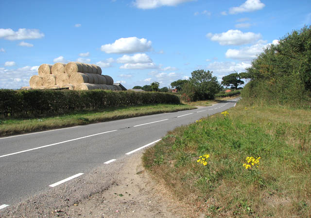 A stack of straw bales beside the B1074