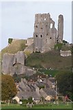 SY9582 : The ruins of Corfe Castle rising behind the village by N Chadwick