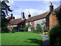 Cottages surrounding the oval churchyard at Hellingly, East Sussex