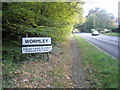 Village boundary sign on the A283