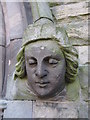 Female stone head on Christ Church west doorway