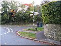 Sign post and seat at cross roads in Bury