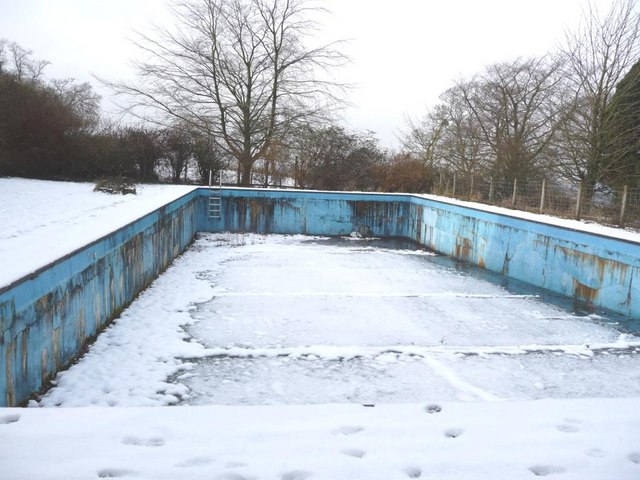 Snow covers the empty swimming pool
