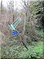 Bent sign by the path